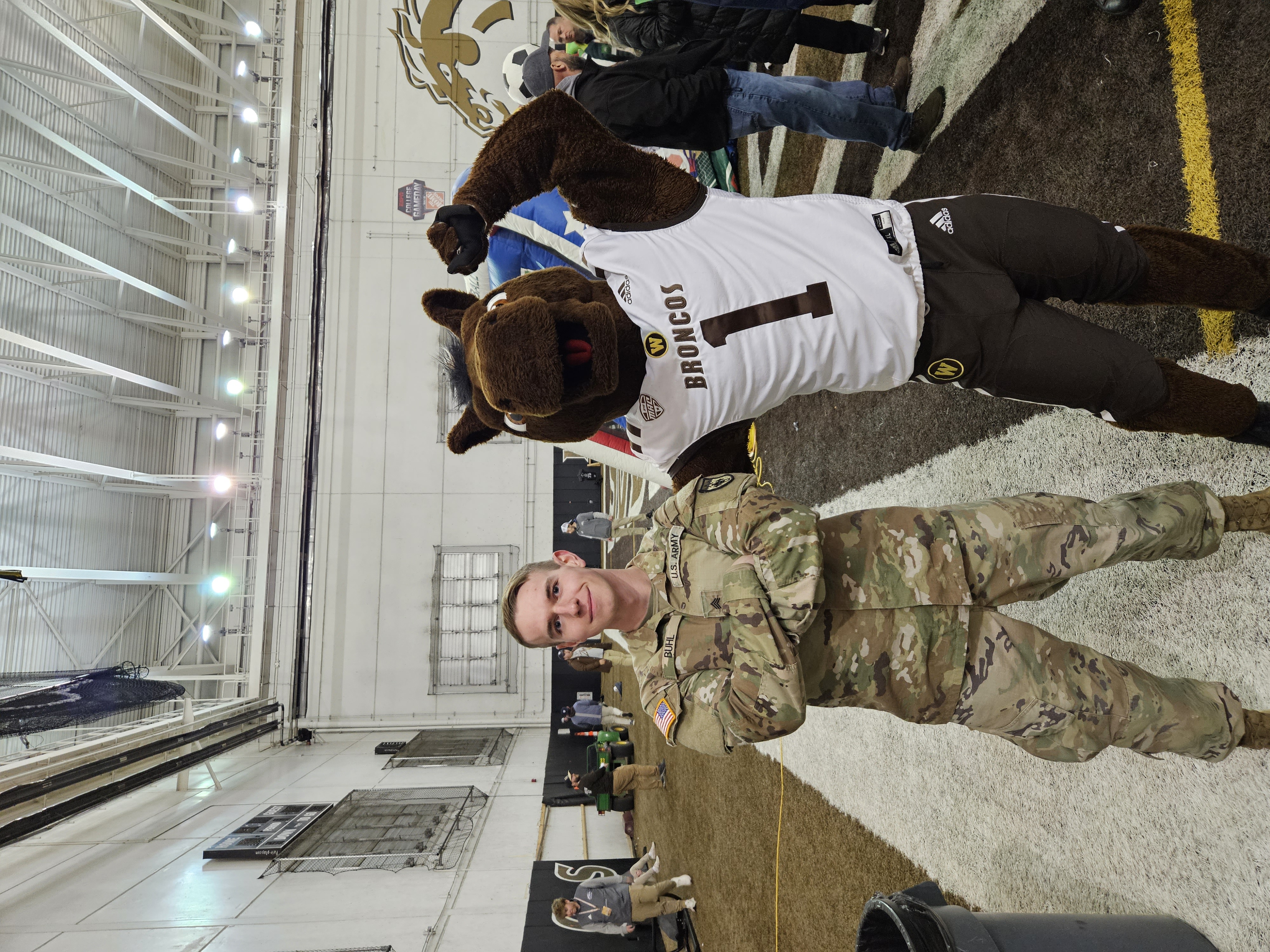 Logan in military uniform with a sports mascot